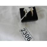 A pair of 14ct gold channel set diamond earrings.