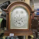 An oak cased chiming mantel clock.
