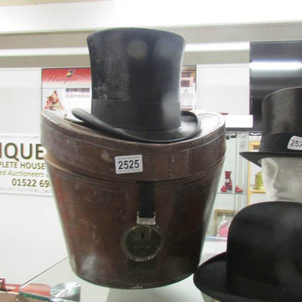 A leather cased silk top hat marked 'Lincoln', Bennett & Co., Sackville Street, Picadilly, London.