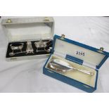 A boxed silver plate cruet set and a boxed silver plate brush.