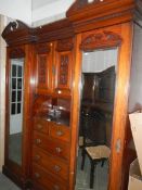 A Victorian combination wardrobe with centre drawer and cupboard.