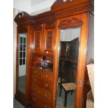 A Victorian combination wardrobe with centre drawer and cupboard.