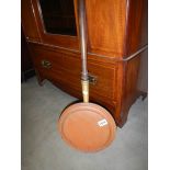 A Victorian copper warming pan.