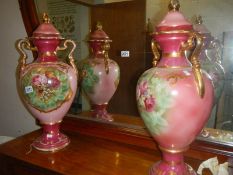 A good pair of large pottery urns (one handle repaired).