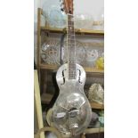 A Republic Resonator Guitar featuring chrome body and with hard case.