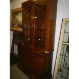 An early 20th century 2 door, 2 drawer oak glazed bookcase.