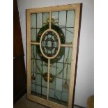 An early art nouveau lead stained glass window in painted frame, circa 1890-1910.