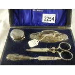A silver manicure set. The scissors are not the correct ones for the set.