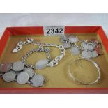 A mixed lot of silver including coin bracelets, chain, childs bracelet etc., approximately 62 grams.