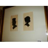 A framed and glazed pair of late 19th century watercolour silhouettes of male and female,