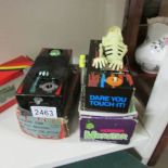 2 boxed tinplate clockwork coffin bank money boxes.