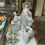 3 Lladro figirines and a Nadal figurine.