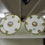 A pair of Minton cabinet plates with hand painted scenes in centres.