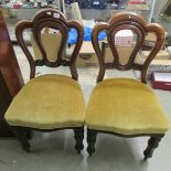 A pair of Victorian mahogany dining chairs.