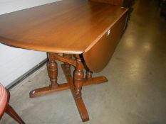 A good quality 4 pillar Ercol style drop leaf table.