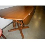 A good quality 4 pillar Ercol style drop leaf table.