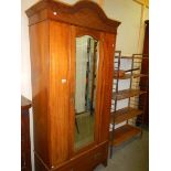 An Edwardian inlaid mirror door wardrobe.