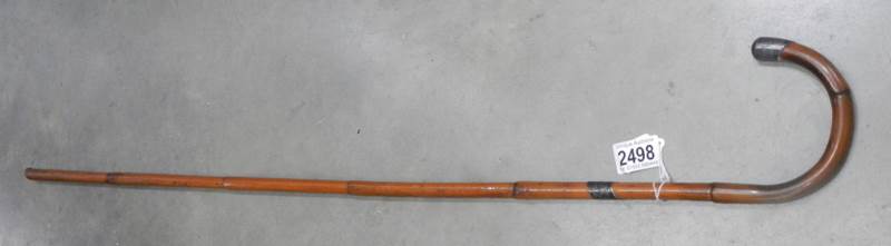 A bamboo walking cane with silver tip. - Image 2 of 2