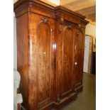 A Victorian mahogany 3 door combination wardrobe with 3 drawers in centre section .