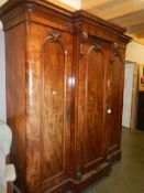 A Victorian mahogany 3 door combination wardrobe with 3 drawers in centre section .