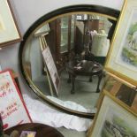 A large antique 19th century oval mirror in good order.