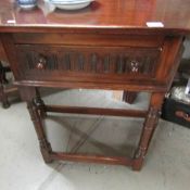 An oak hall table with drawer.