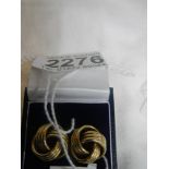 A pair of 3.7g yellow gold knot screw fittng earrings.