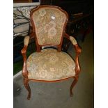 An upholstered elbow chair.