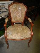 An upholstered elbow chair.