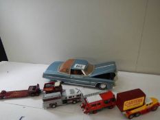 A 1:18 scale Cadillac with moving parts and 4 smaller model vehicles.