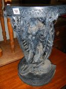 A small late 20th century resin table with dragon base, 20" high.