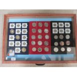 A jewellery display case containing various commemorative coins including crowns, 50p,