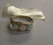 A 3 stone opal ring set in 9ct yellow gold.