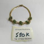 A 14 ct gold 6.8 gram jade bracelet.