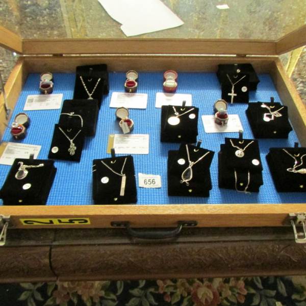 A display case containing 6 silver rings, all with certificates, and 10 silver pendants. - Image 2 of 23