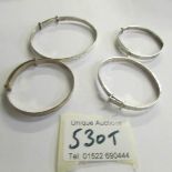 4 silver bangles.