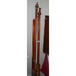 A quantity of Victorian wooden curtain poles with rings.