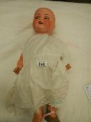 A Victorian porcelain headed doll, missing wig, 18".