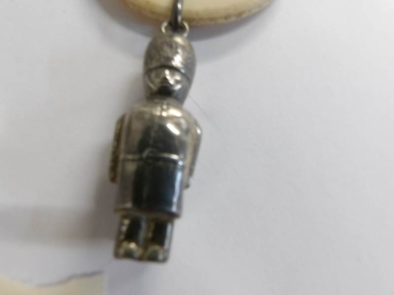 An early 20th century childs silver rattle with teething ring together with a silver fob dated - Image 2 of 4