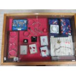 A display case of silver bangles, charms, earrings etc., (this lot is buyer collect only).