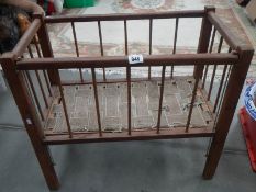 An old dolls cot with drop sides.