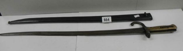 A long French bayonet in original scabbard (70 cm / 27.5" long).