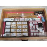 A display case containing silver rings, silver chains, other jewellery and watches etc.