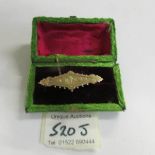 A 3 gram Chester hall mark yellow gold brooch in satin box.