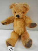 An old straw filled Teddy bear, 12" tall, in good order.