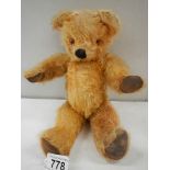 An old straw filled Teddy bear, 12" tall, in good order.