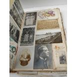 A large and voluminous Victorian and Edwardian Album containing postcards,cigarette cards,