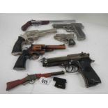 A quantity of replica hand guns.