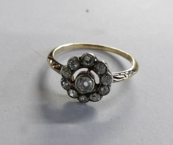 An Edwardian old cut diamond cluster ring fashioned as a daisy in 18ct gold, size M half.