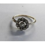 An Edwardian old cut diamond cluster ring fashioned as a daisy in 18ct gold, size M half.